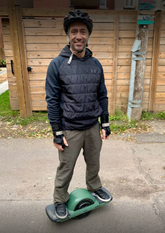 Man Riding on Green Onewheel